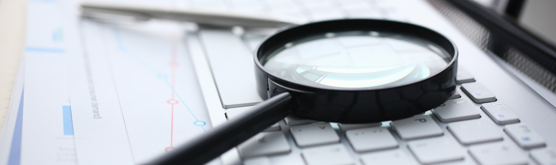 Magnifying glass, chart and keyboard for testing